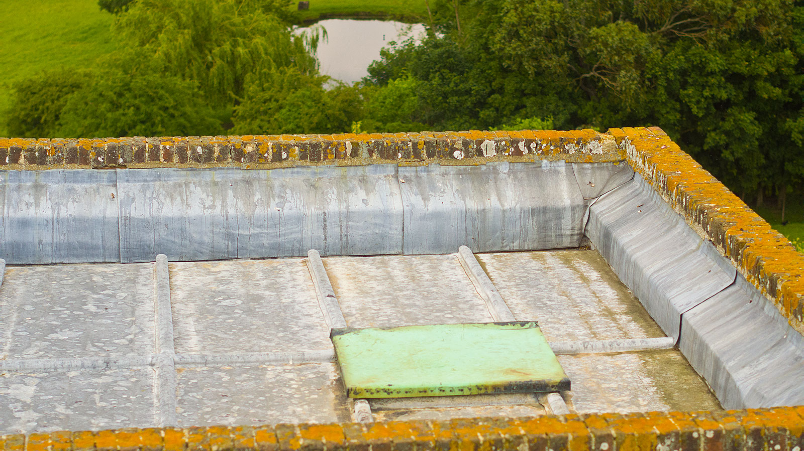 Aerial photograph showing extreme close up view of a church roof in Essex