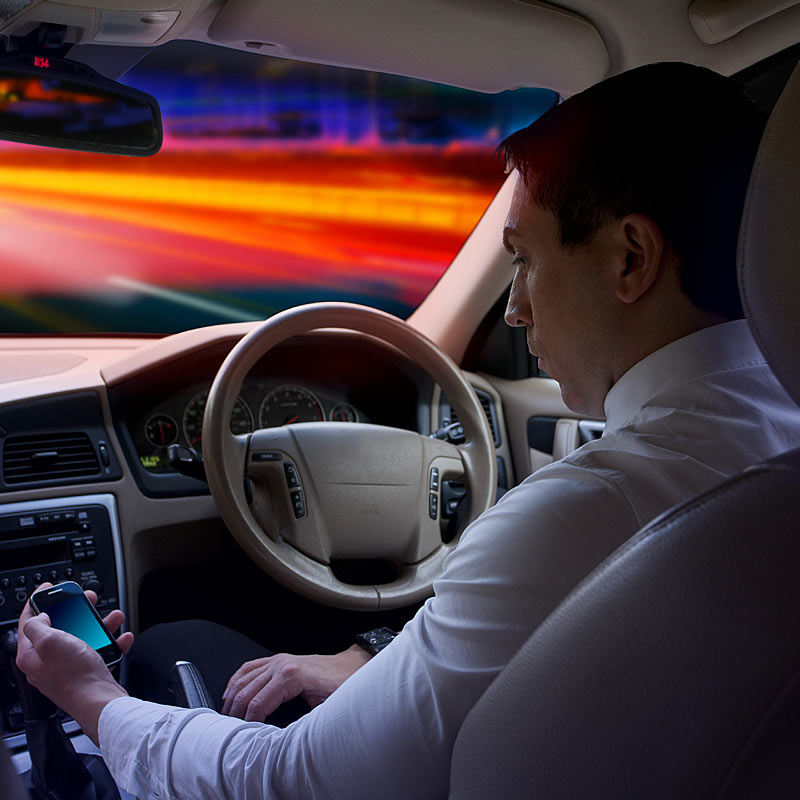 Photograph of businessman in car